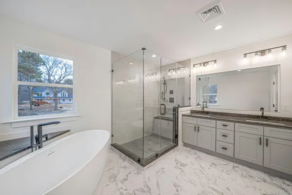 a bathroom with a granite countertop sink a toilet and bathtub