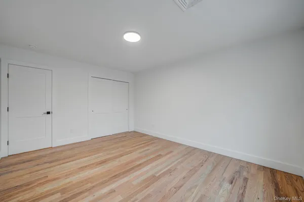 a view of a hallway with wooden floor and stairs