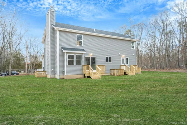 a front view of a house with a garden and yard