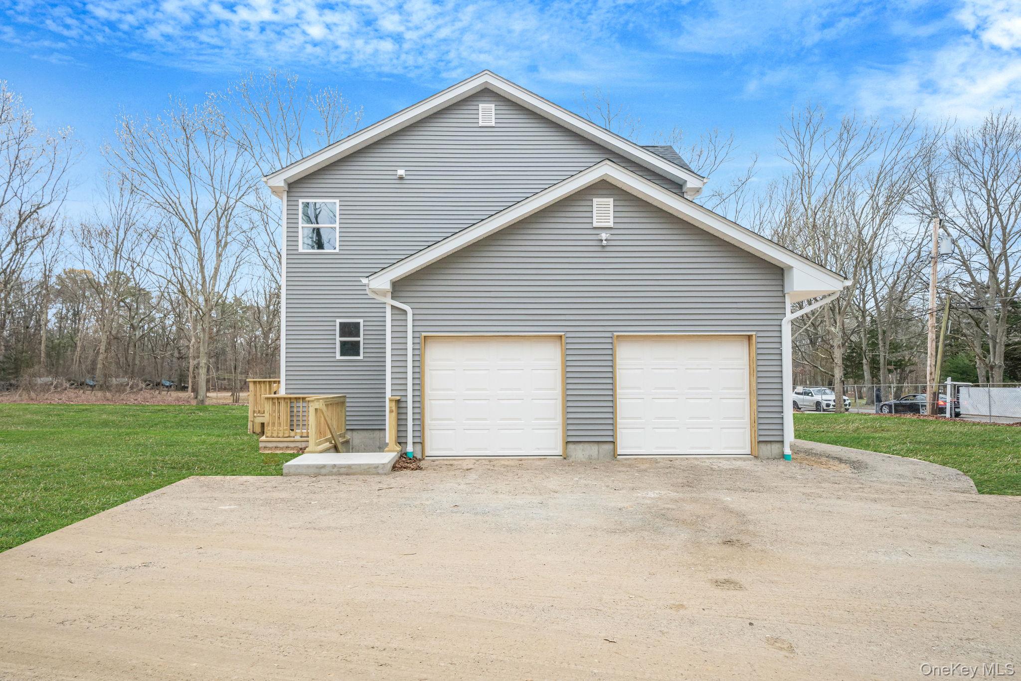 63 A Blydenburgh Road Centereach, NY 11720 - Photo 36 of 38 a front view of house with yard and trees