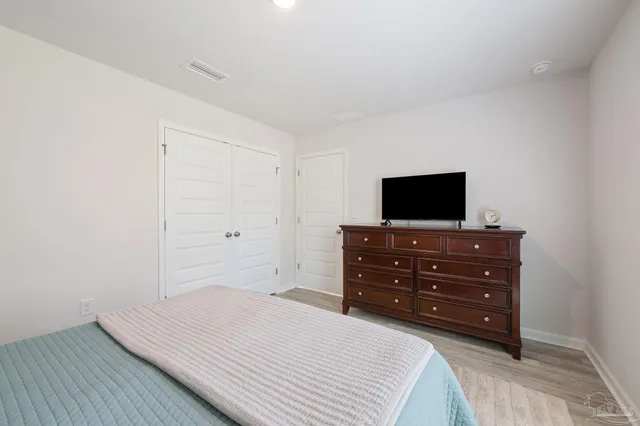 a room with a bed and a flat screen tv