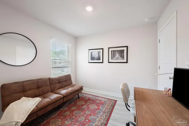 a living room with furniture a couch and a flat screen tv
