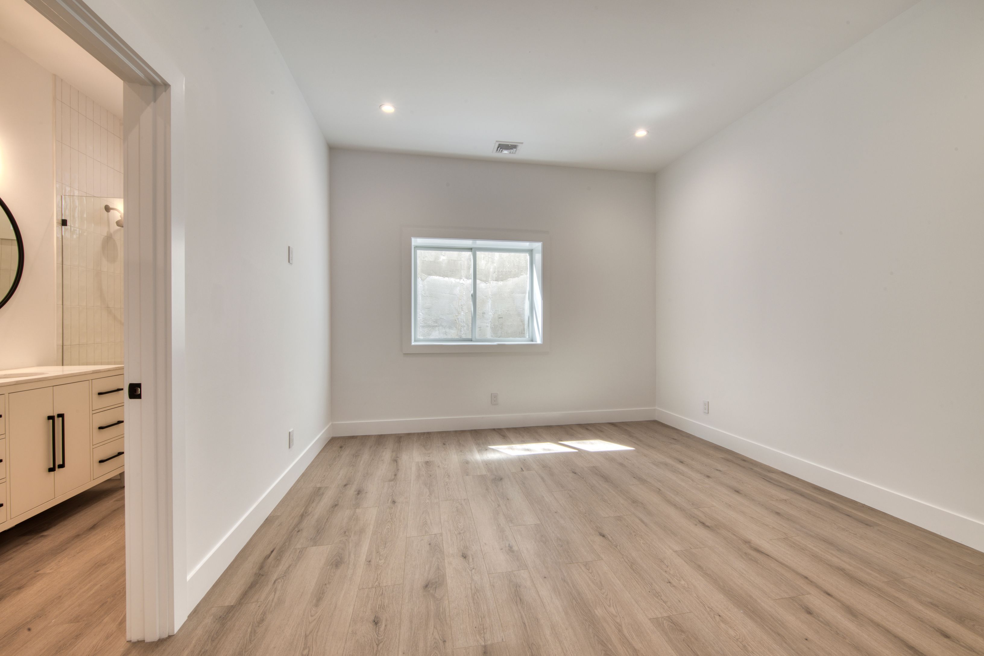 18 Barnes Avenue East Hampton, NY 11937 - Photo 22 of 35 a view of an empty room with wooden floor and a window