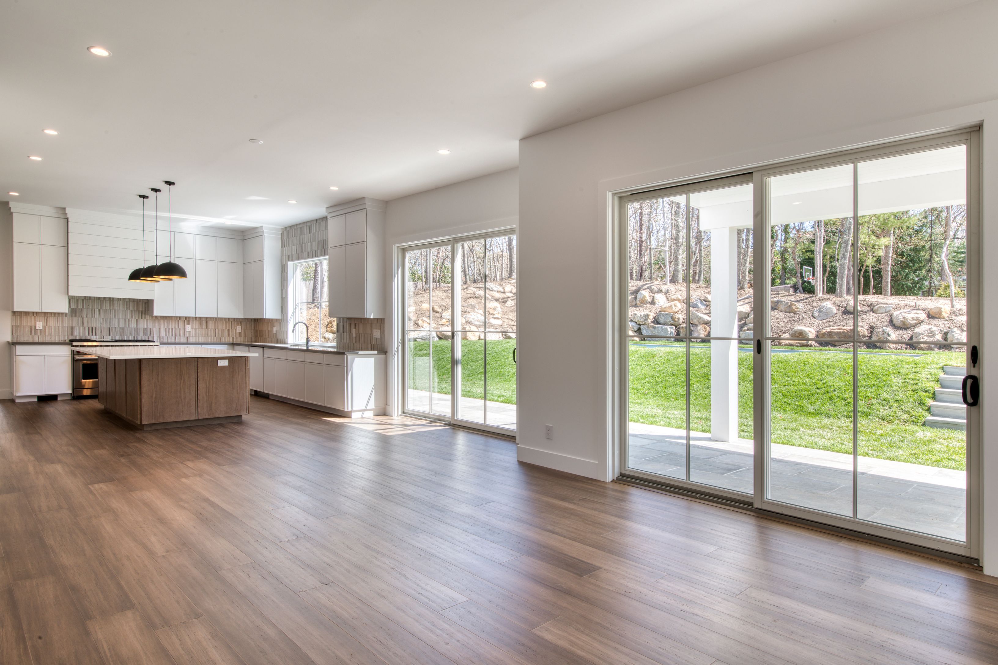 18 Barnes Avenue East Hampton, NY 11937 - Photo 8 of 35 a open kitchen with kitchen island a large window cabinets and stainless steel appliances