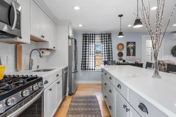 a kitchen with stainless steel appliances granite countertop a sink stove and cabinets
