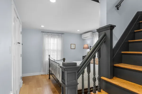 a view of entryway with wooden floor and stairs