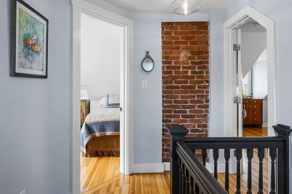 a view of a hallway to a livingroom with furniture