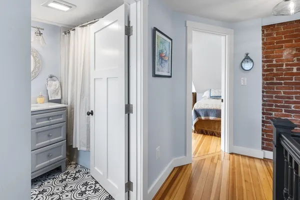 a bathroom with a toilet a sink and a window