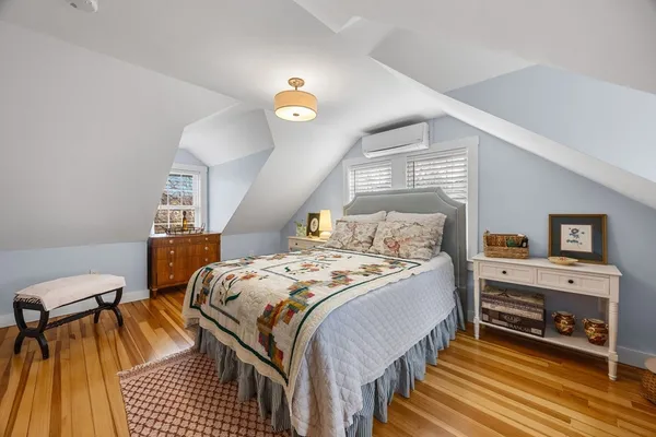 a bedroom with a bed a chair and the potted plant