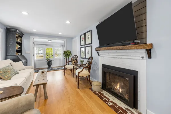 a living room with furniture a flat screen tv and a fireplace