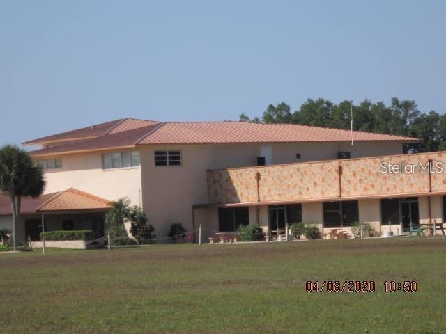 Calendula Drive Frostproof, FL 33843 - Photo 7 of 13 a front view of a house with a garden and porch