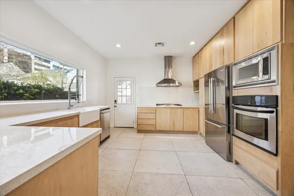 a kitchen with stainless steel appliances kitchen island granite countertop a sink and cabinets