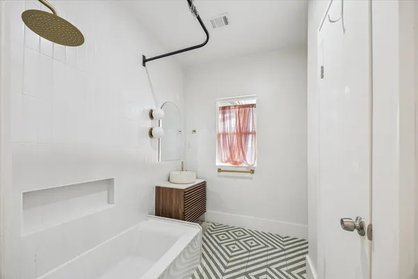 a bathroom with a bathtub and a shower