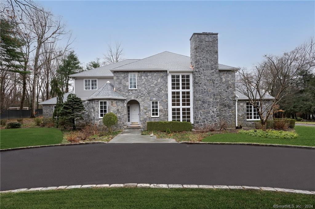 a front view of a house with a garden and yard