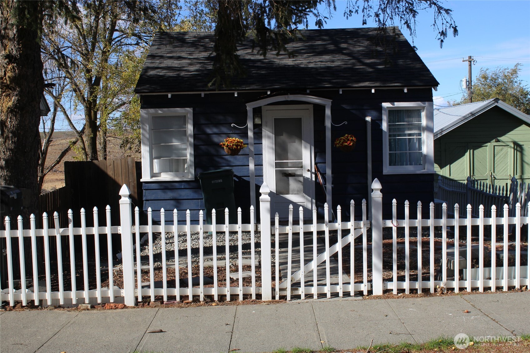 a view of a brick house with wooden fence