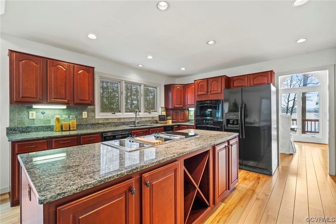 13703 Beechwood Point Road Midlothian, VA 23112 - Photo 16 of 50 a kitchen with stainless steel appliances granite countertop a stove a sink dishwasher and a refrigerator with wooden floor