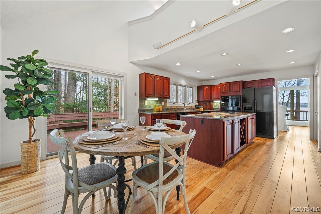 13703 Beechwood Point Road Midlothian, VA 23112 - Photo 17 of 50 a open dining room with stainless steel appliances kitchen island granite countertop a kitchen island a table and chairs in it