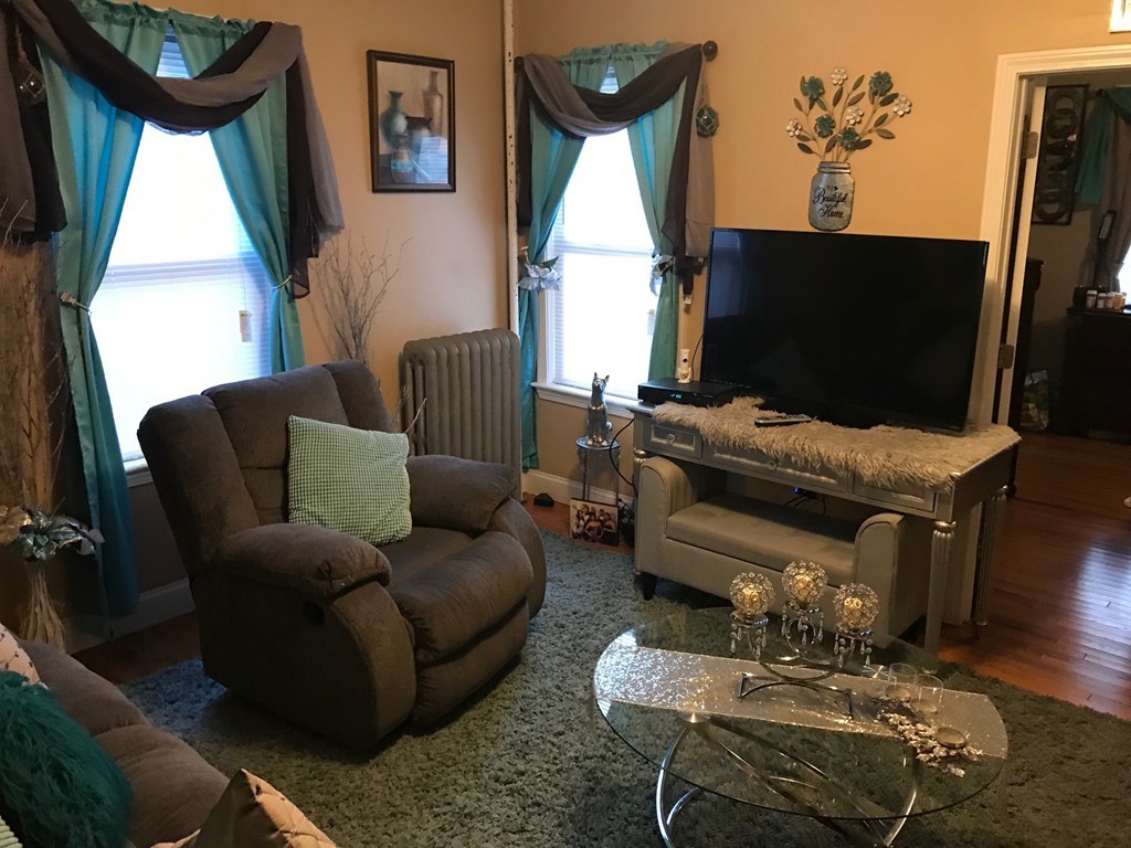 71 Birch Street Worcester, MA 01603 - Photo 13 of 23 a living room with furniture a flat screen tv and a window