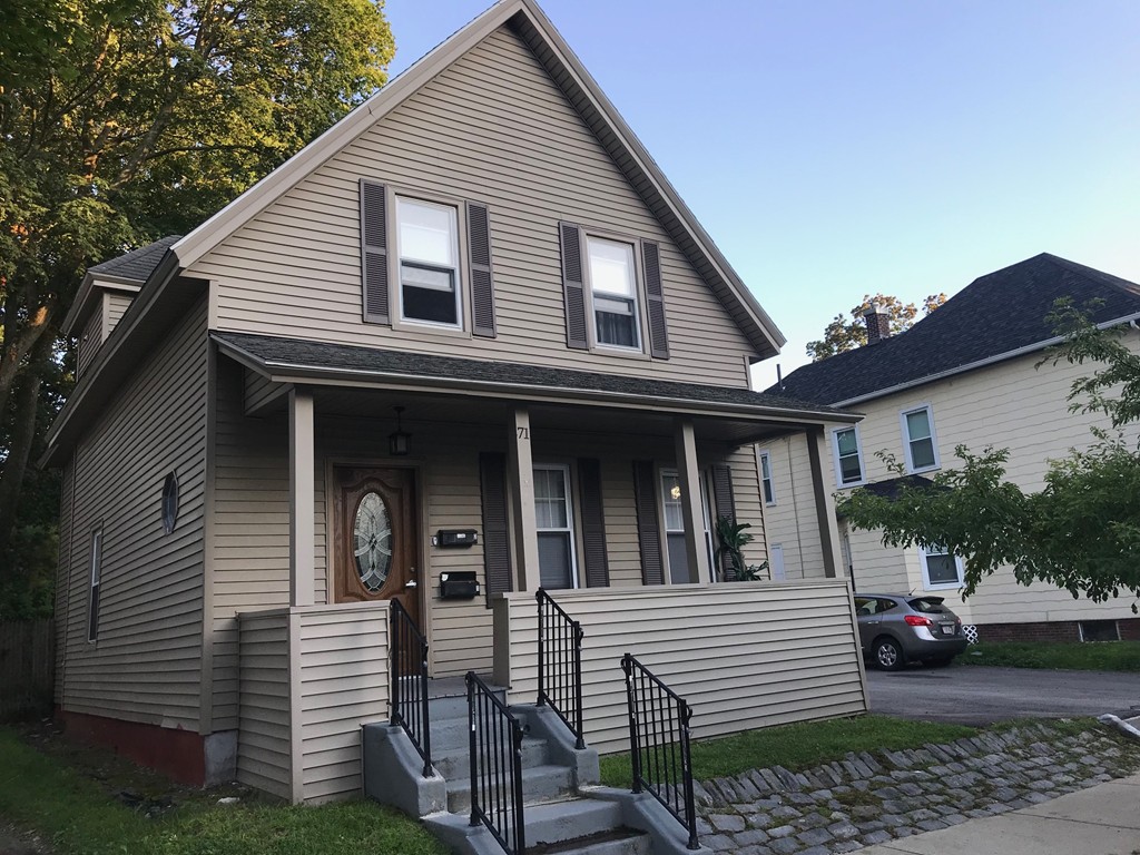 71 Birch Street Worcester, MA 01603 - Photo 2 of 23 a view of a white house with large windows and potted plants