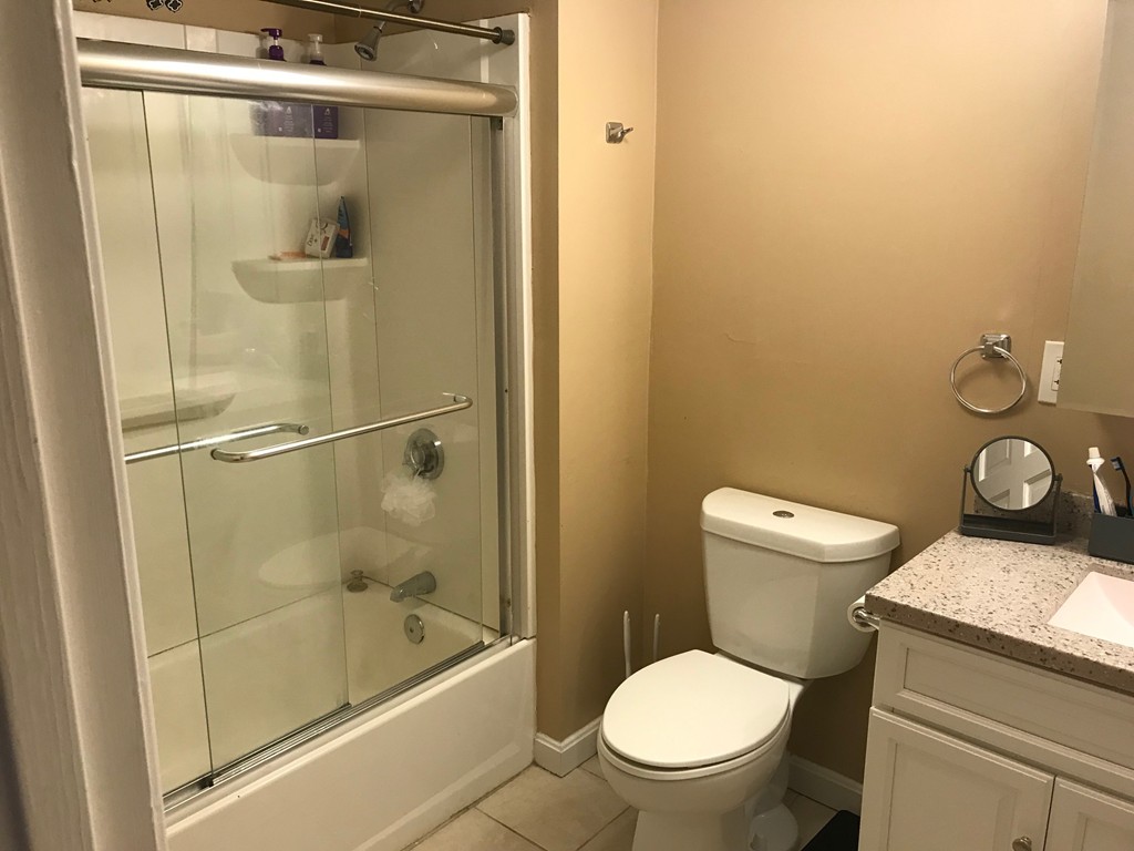 71 Birch Street Worcester, MA 01603 - Photo 7 of 23 a white toilet sitting next to a bath tub and a shower