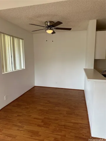 a view of a room with wooden floor and cabinet