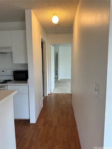 a view of a hallway with entryway wooden floor and front door