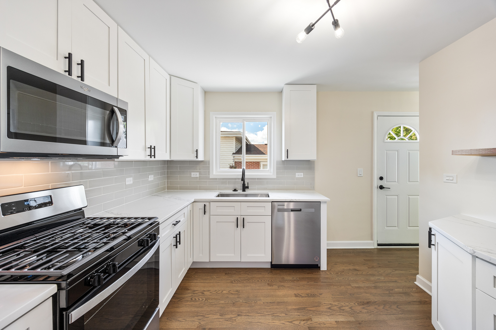 5821 Warren Street Morton Grove, IL 60053 - Photo 11 of 27 a kitchen with stainless steel appliances a stove microwave and cabinets