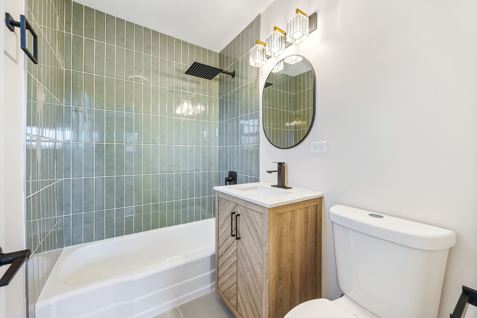 5821 Warren Street Morton Grove, IL 60053 - Photo 15 of 27 a bathroom with a sink a toilet and a mirror