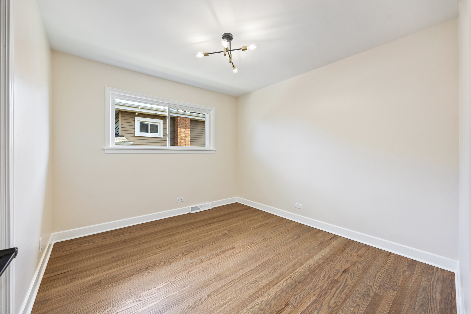 5821 Warren Street Morton Grove, IL 60053 - Photo 16 of 27 an empty room with a window and a ceiling fan