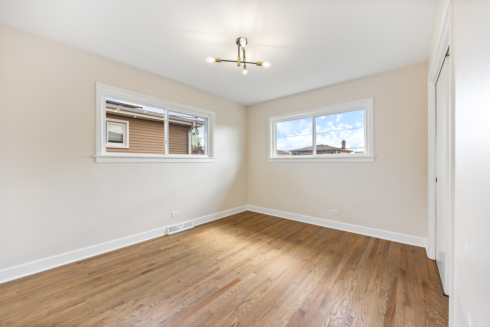5821 Warren Street Morton Grove, IL 60053 - Photo 18 of 27 a view of empty room with wooden floor and fan