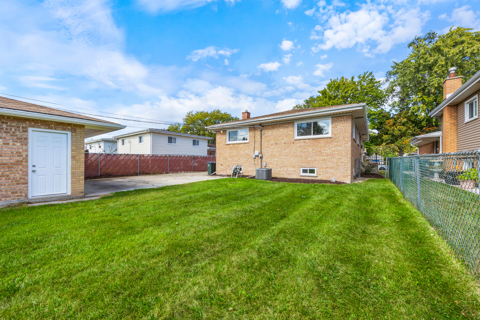 5821 Warren Street Morton Grove, IL 60053 - Photo 25 of 27 a view of a yard in front of a house with plants and large tree