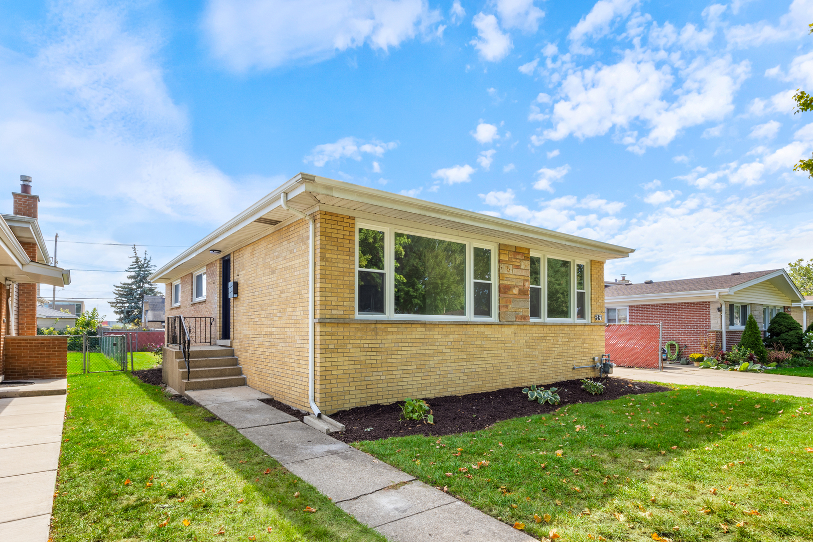 5821 Warren Street Morton Grove, IL 60053 - Photo 3 of 27 a front view of a house with garden