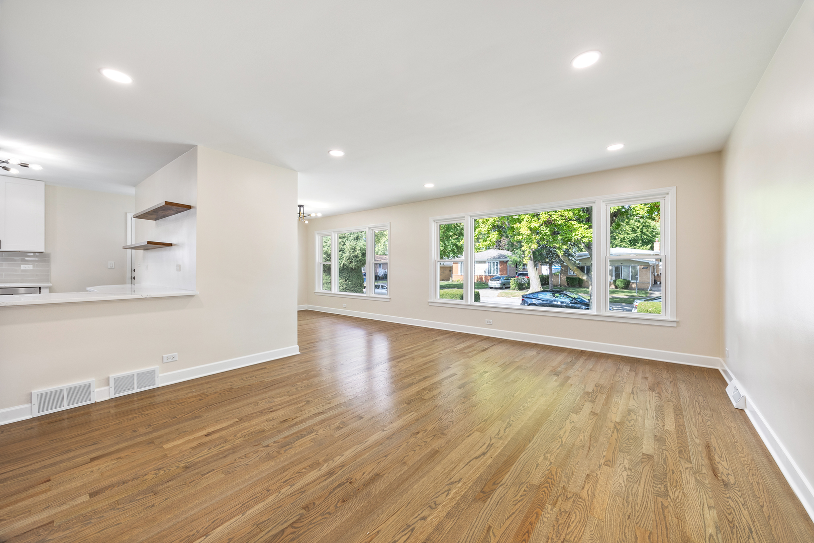 5821 Warren Street Morton Grove, IL 60053 - Photo 4 of 27 a view of an empty room with wooden floor and a window