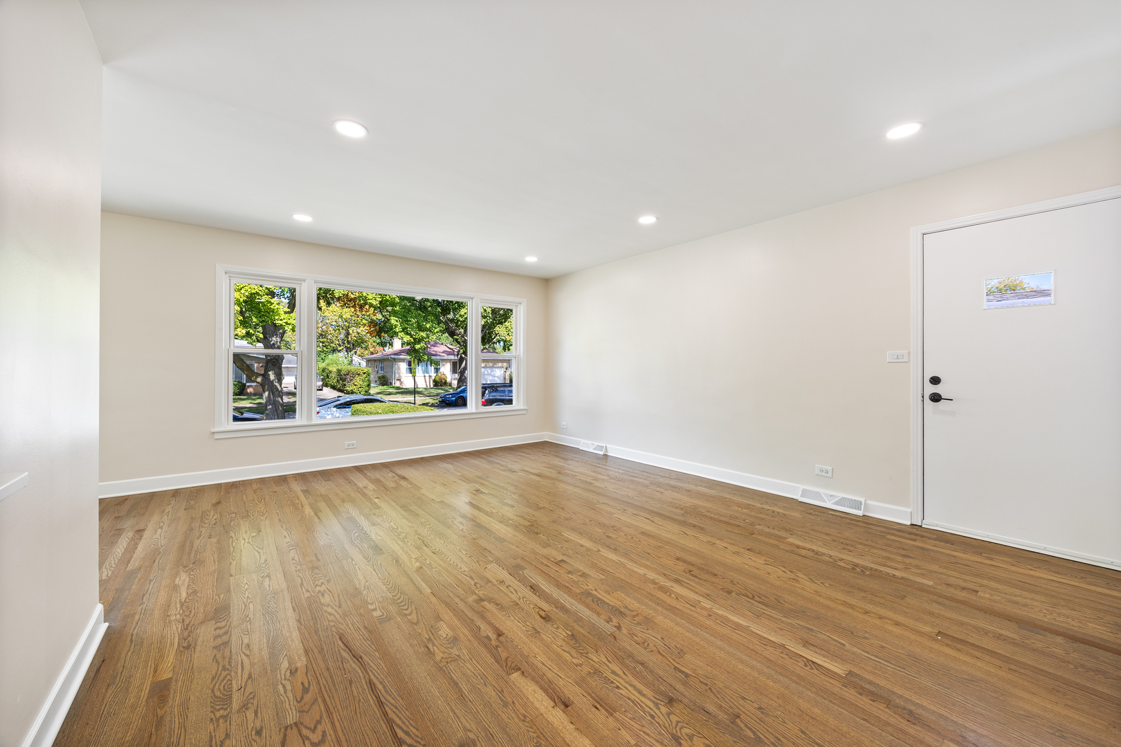 5821 Warren Street Morton Grove, IL 60053 - Photo 5 of 27 wooden floor in an empty room with a window
