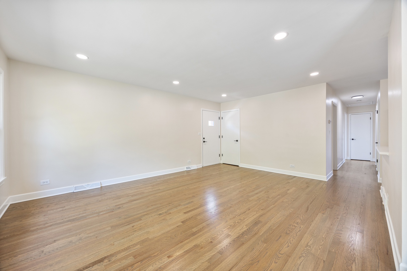 5821 Warren Street Morton Grove, IL 60053 - Photo 7 of 27 a view of an empty room with wooden floor
