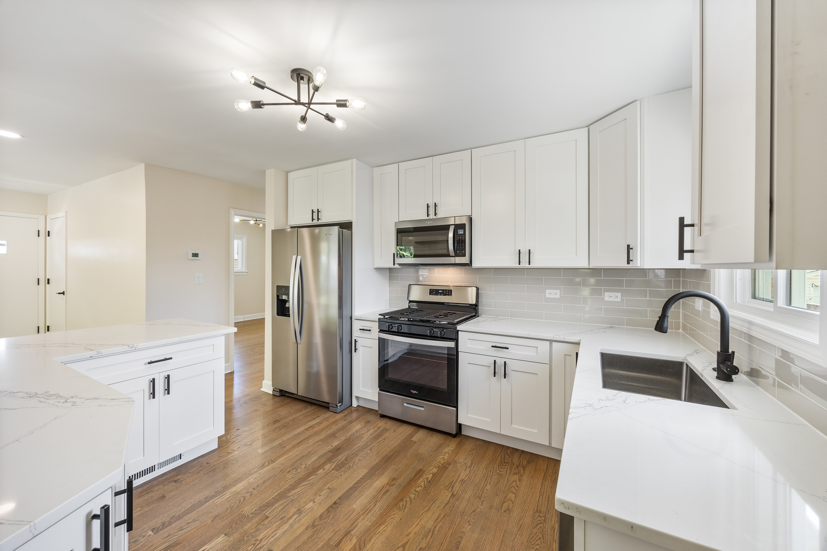 5821 Warren Street Morton Grove, IL 60053 - Photo 9 of 27 a kitchen with granite countertop a sink stainless steel appliances and cabinets