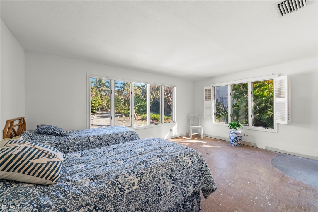 16632 Captiva Drive Captiva, FL 33924 - Photo 21 of 38 a large bedroom with a bed and wooden floor