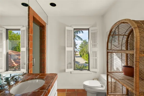 a bedroom with furniture and a large window