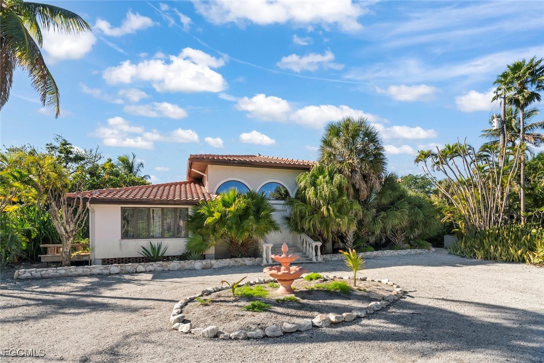 16632 Captiva Drive Captiva, FL 33924 - Photo 34 of 38 front view of a house with a fountain