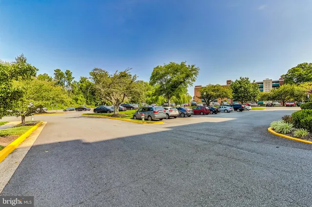 a view of an apartment with swimming pool and a yard