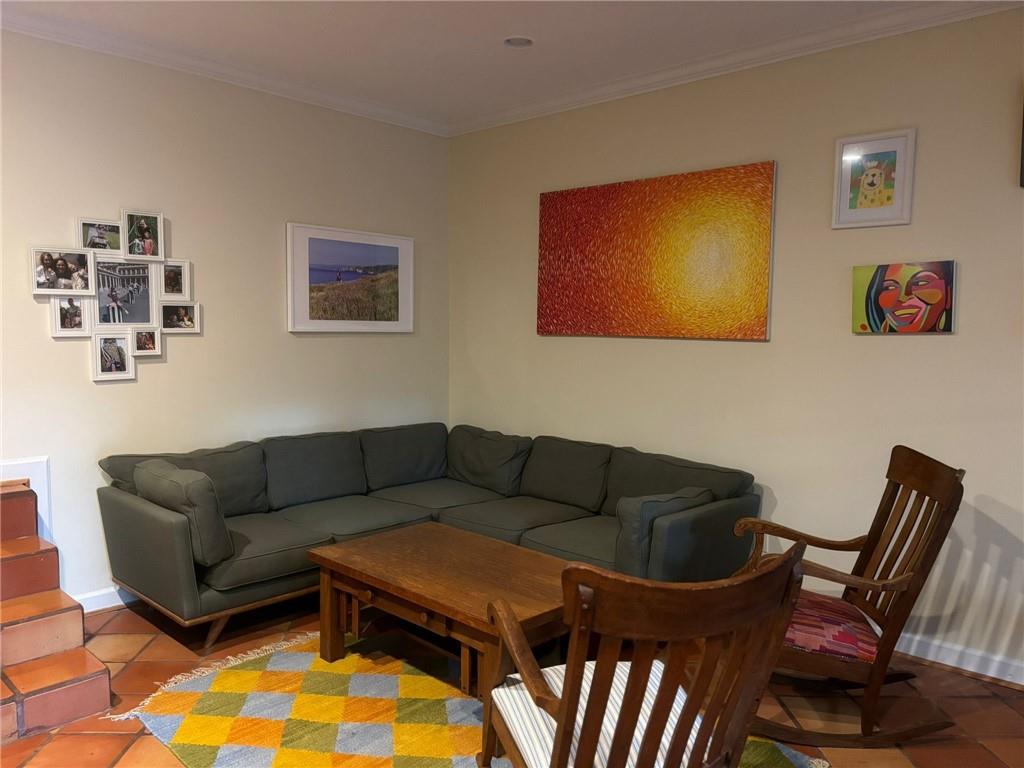 544 East Ponce De Leon Avenue, Unit TERRACE Decatur, GA 30030 - Photo 10 of 18 a living room with furniture a rug and a wall painting