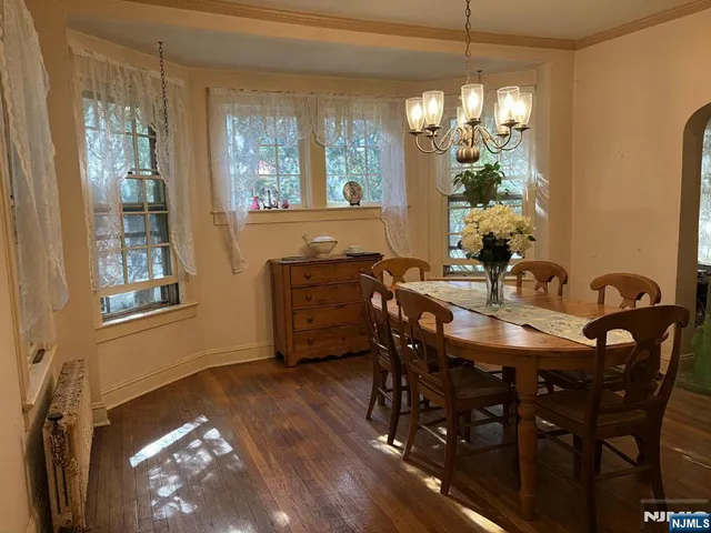 a dining room with furniture a chandelier and window
