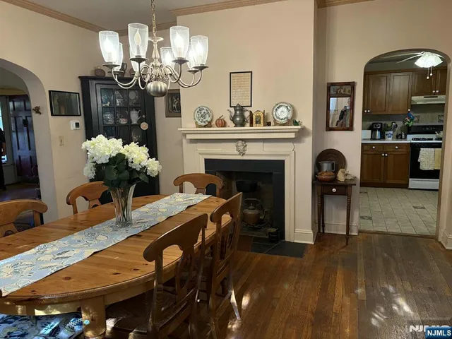 a view of a dining room with furniture and chandelier