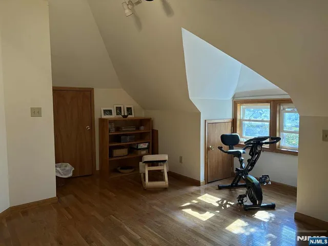 a view of a workspace with furniture and wooden floor