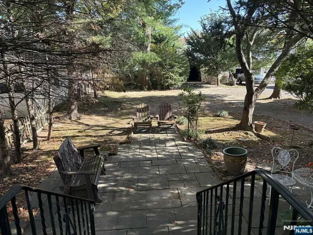 a view of a wooden deck and a backyard
