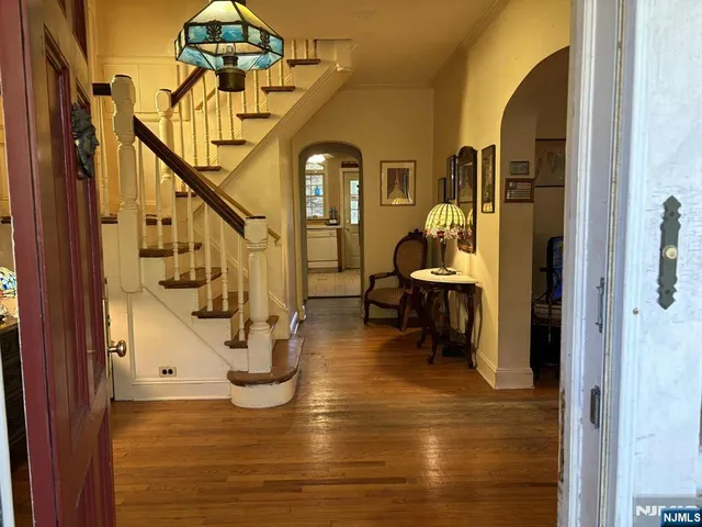 a view of entryway and hall with wooden floor