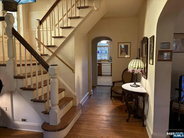 a view of entryway and hall with wooden floor