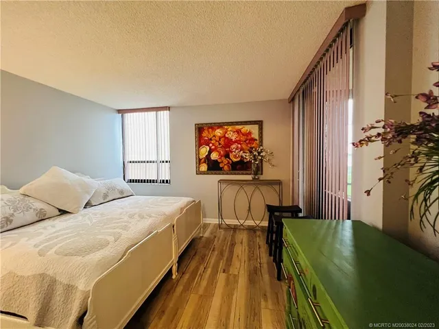 a bathroom with a sink a toilet a mirror and shower