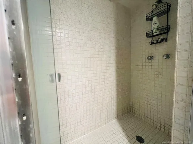 a bedroom with a bed and large windows