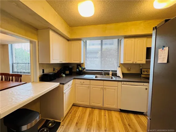 a kitchen with a sink and stainless steel appliances